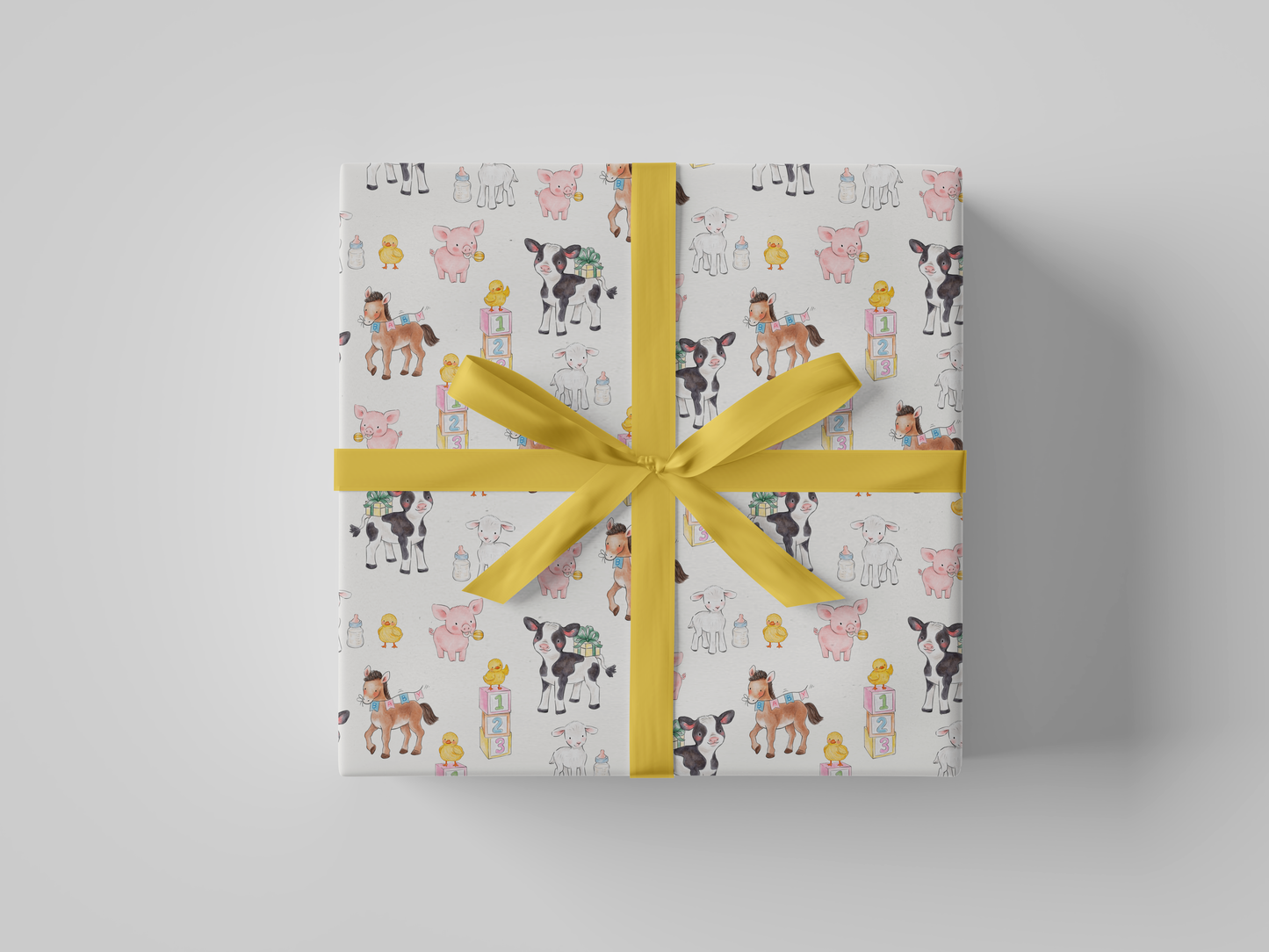 Front view of light cream wrapping paper featuring a whimsical pattern of baby farm animals, including cows, pigs, lambs, ducklings, and ponies, surrounded by baby bottles, gift boxes, and pastel alphabet blocks.
