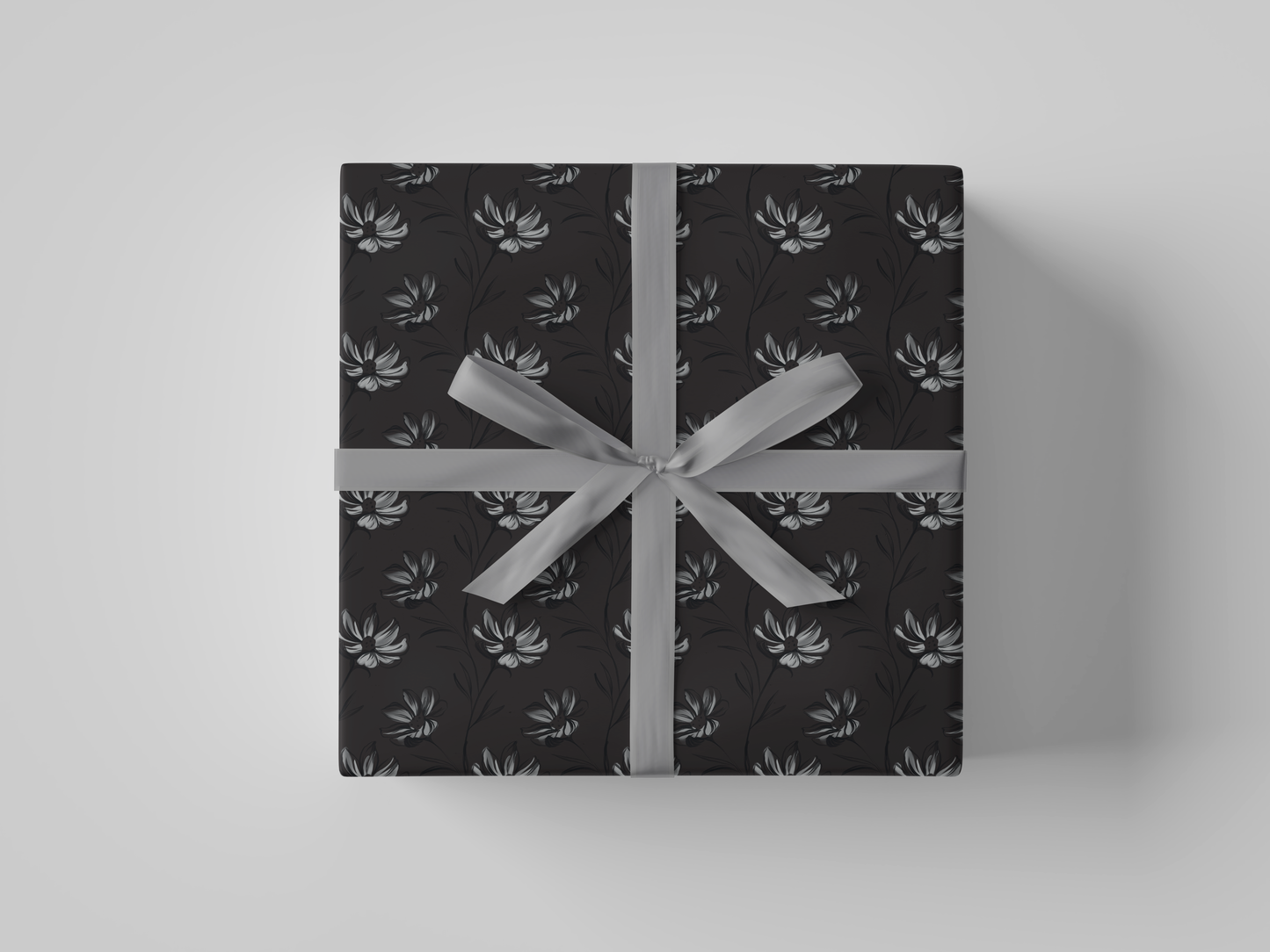Front view of dark gray wrapping paper featuring intricate hand-drawn botanical illustrations in a structured floral design