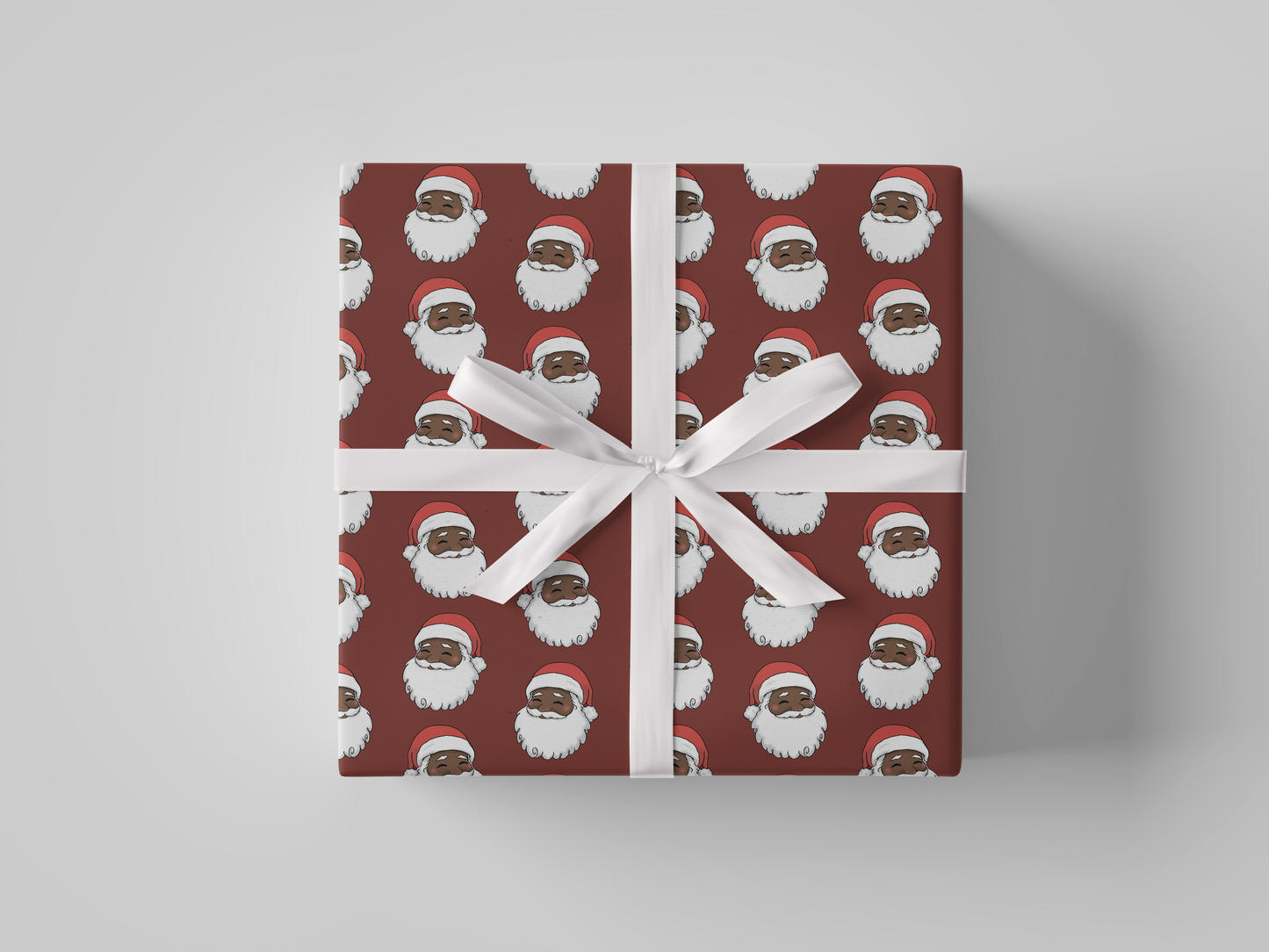 Front view of Christmas wrapping paper featuring a smiling Santa Claus wearing a red hat, set against a deep red background.