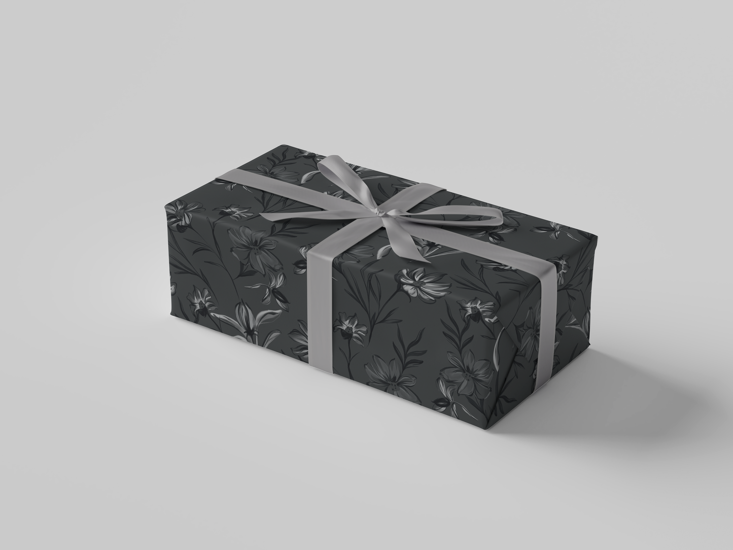 Side view of dark gray floral-patterned wrapping paper with black and gray flowers and leaves.