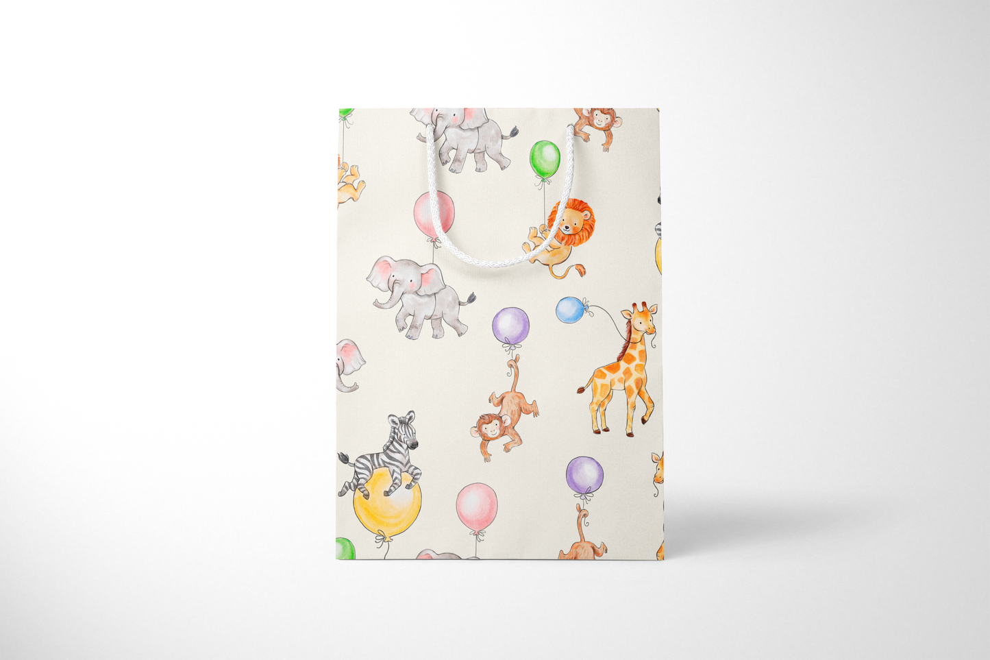 Front view of light cream gift bag featuring a playful pattern of watercolor-style jungle animals, including lions, elephants, giraffes, monkeys, and zebras with colorful balloons, complete with white rope handles.