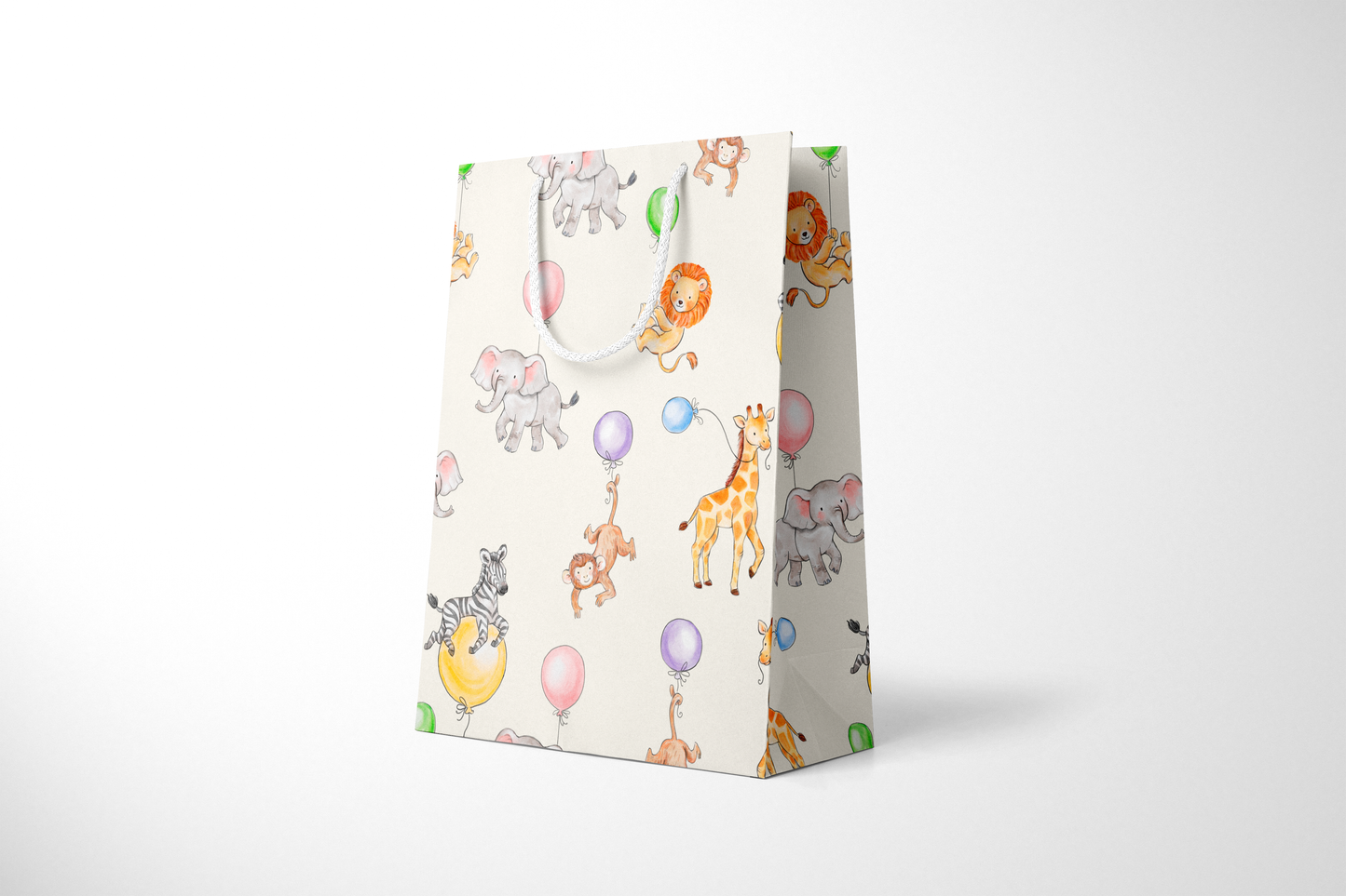 Side view of light cream gift bag featuring a playful pattern of watercolor-style jungle animals, including lions, elephants, giraffes, monkeys, and zebras with colorful balloons, complete with white rope handles.