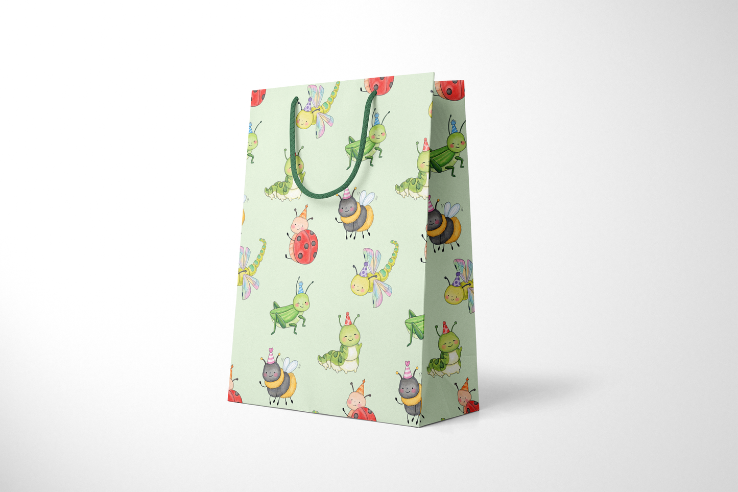 Side view of mint green gift bag featuring a playful pattern of watercolor-style party bugs, including ladybugs, bees, caterpillars, dragonflies, and grasshoppers wearing party hats, with dark green rope handles.