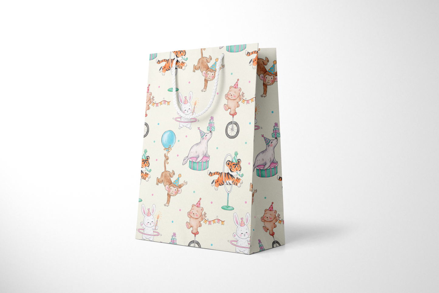 Side view of light cream gift bag featuring a whimsical pattern of circus animals, including monkeys doing handstands, bears on unicycles, bunnies with hula hoops, tigers jumping through hoops, and seals balancing gifts, all wearing party hats, decorated with white rope handles and scattered lavender and blue confetti polka dots.