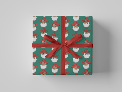 Front view of smiling Cowboy Santa Claus in a red cowboy hat, featured on green-colored Christmas wrapping paper