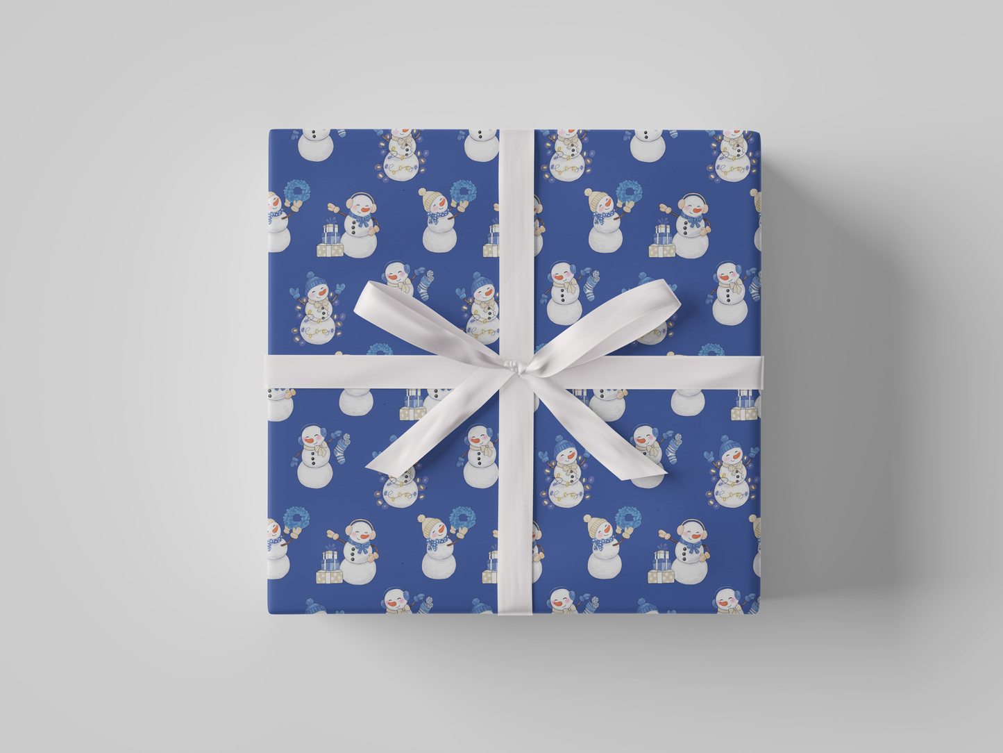 Front view of blue-colored wrapping paper featuring blue and white snowladies holding Christmas gifts, stockings, wreaths, and Christmas tree lights.