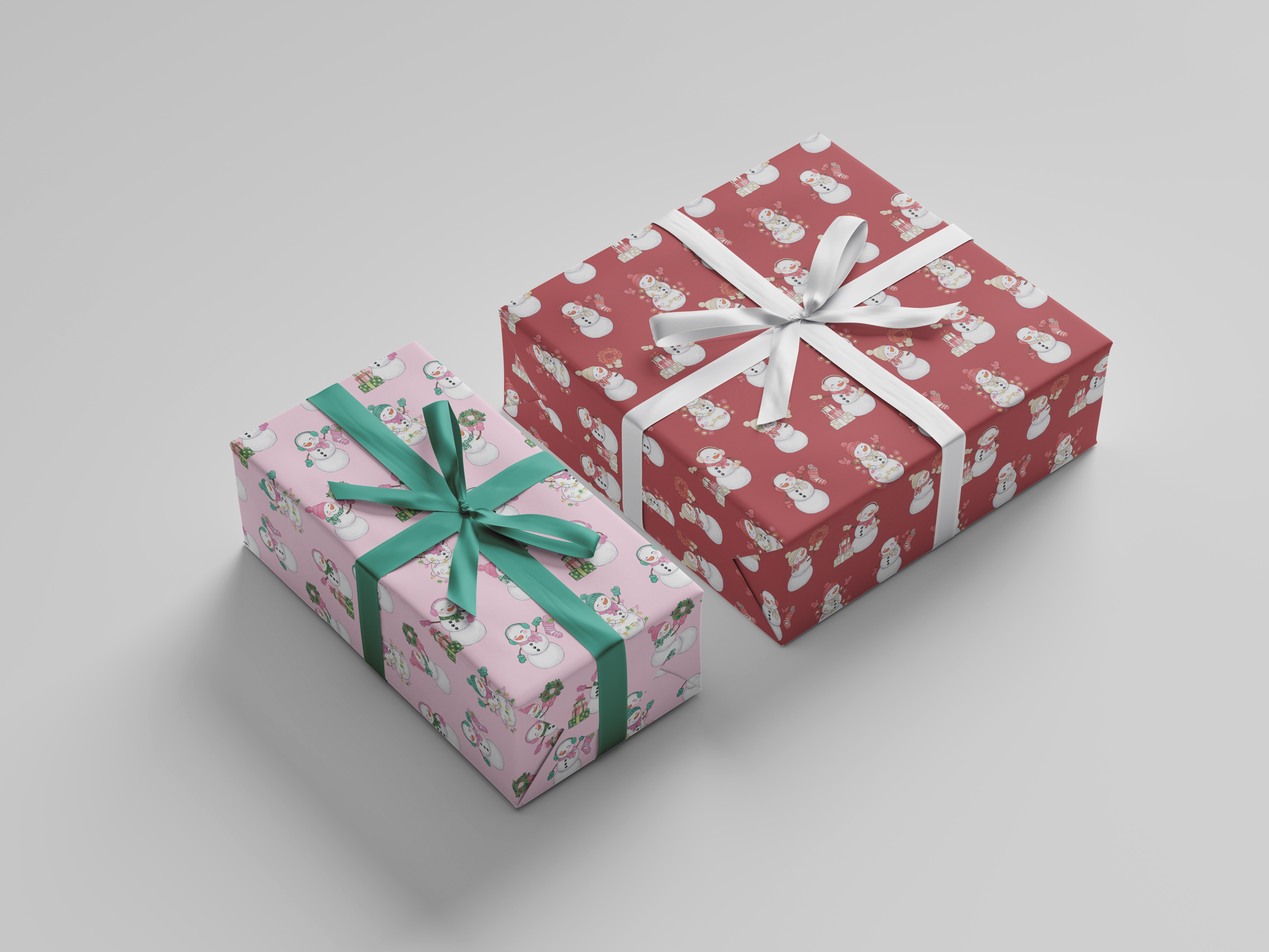 Side view of pink and green and red and white snowladies holding Christmas gifts, stockings, wreaths, and Christmas tree lights posed against a backdrop of pink-colored wrapping paper and red-colored wrapping paper