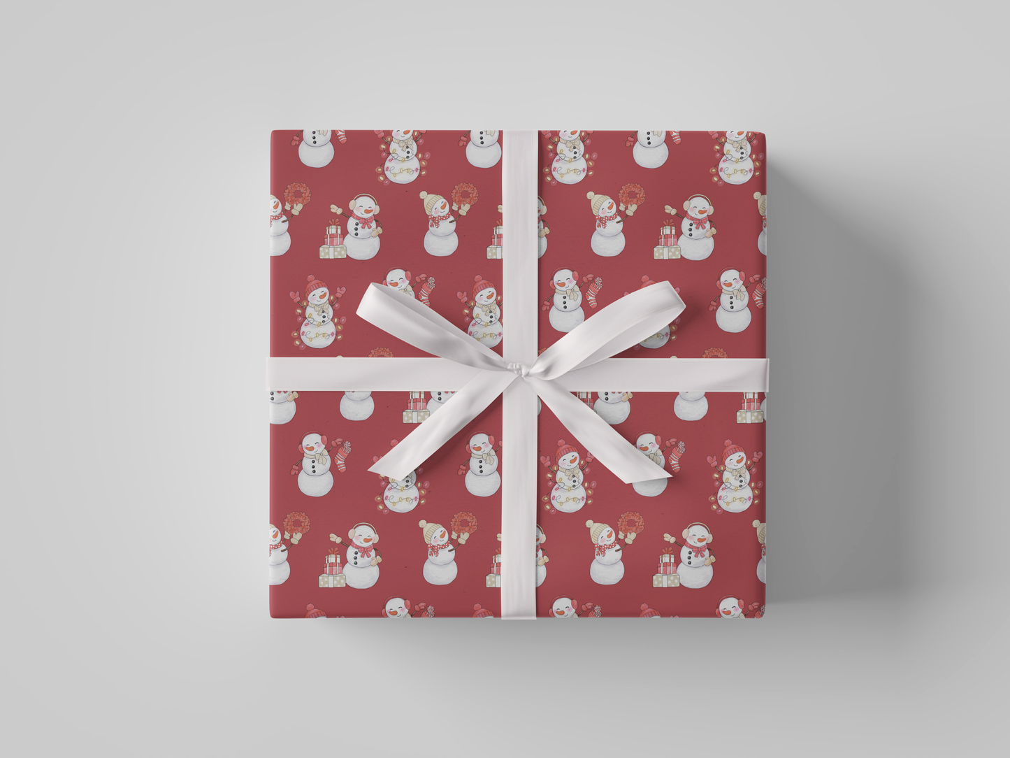 Front view of red-colored wrapping paper featuring red and white snowladies holding Christmas gifts, stockings, wreaths, and Christmas tree lights.