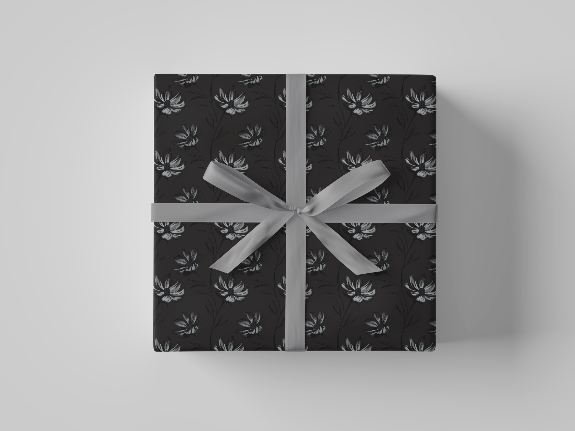 Front view of dark gray wrapping paper featuring intricate hand-drawn botanical illustrations in a structured floral design