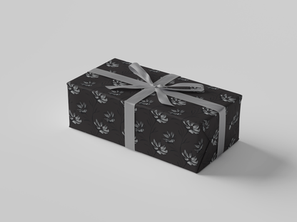 Side view of dark gray wrapping paper featuring intricate hand-drawn botanical illustrations in a structured floral design