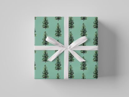 Front view of Christmas wrapping paper featuring dark green Christmas trees with glowing yellow lights on mint green background 