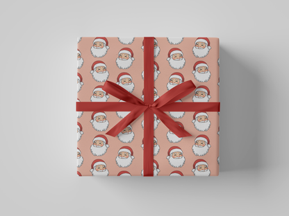 Front view of Christmas wrapping paper featuring a smiling Santa Claus wearing a red hat, set against a peach background.