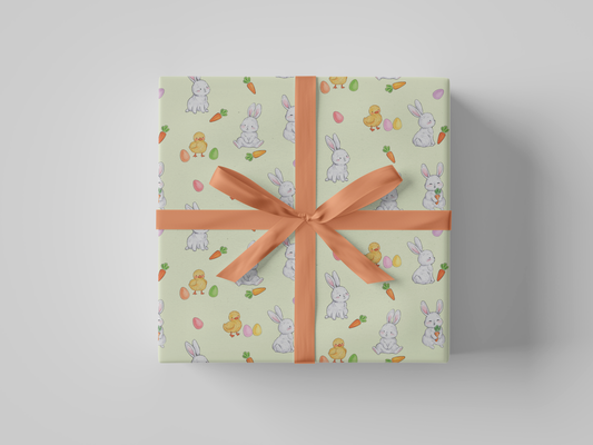 Front view of light yellow Easter wrapping paper showcasing white bunnies, yellow baby chicks, carrots, and pastel-colored eggs.