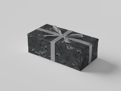 Side view of dark gray floral-patterned wrapping paper with black and gray flowers and leaves.