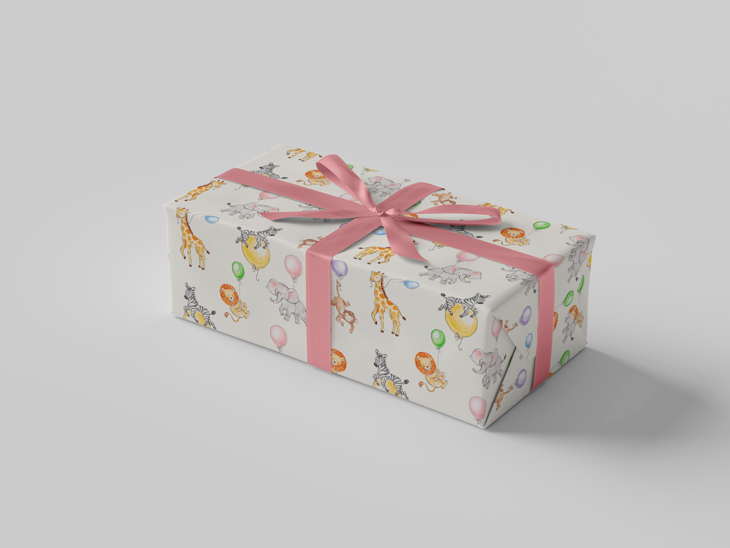 Side view of wrapping paper featuring watercolor illustrations of jungle animals - elephants, giraffes, lions, and zebras - celebrating with colorful balloons on a cream background.